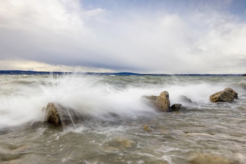 Storm Lolita raging on the rocky shore with waves in Hagnau