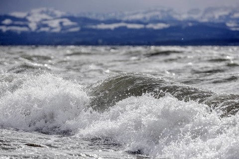Storm Lolita raging on the rocky shore with waves in Hagnau