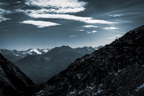 Mountaineers on mountain ridge in the background glaciated mountains