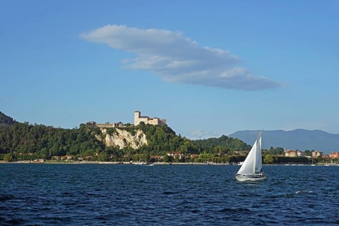 Sailing boat and castle of Angera or Rocca Borromeo di Angera