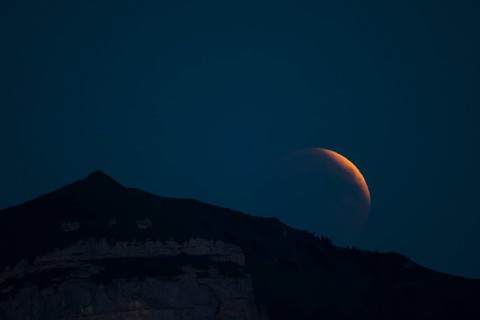 Lunar eclipse above the mountain station of Hohen Kasten
