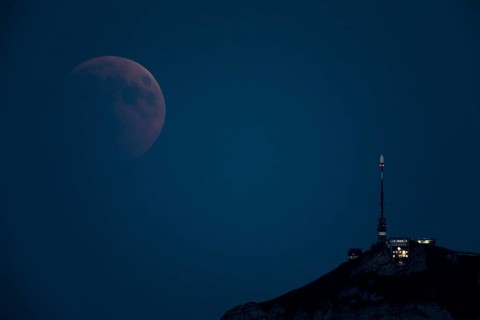 Lunar eclipse above the mountain station of Hohen Kasten