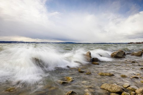 Storm Lolita raging on the rocky shore with waves in Hagnau