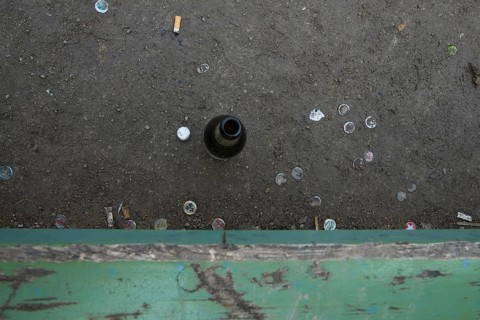 Empty beer bottle on a park bench at Heidelberger Platz