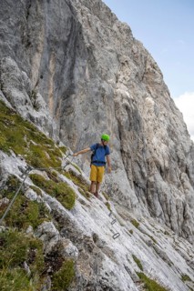 Young man climbing in via ferrata