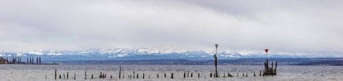 Old wooden groynes at low water and storm on Lake Constance