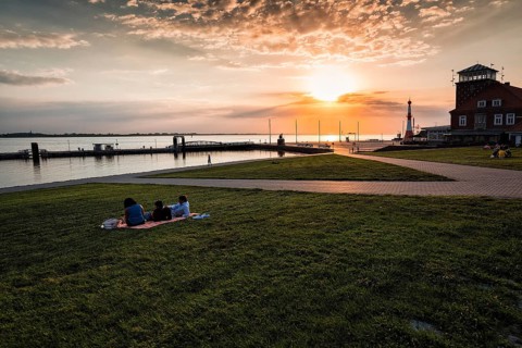 View of the Weser estuary and Strandhalle at sunset from the dyke