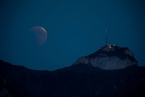 Lunar eclipse above the mountain station of Hohen Kasten