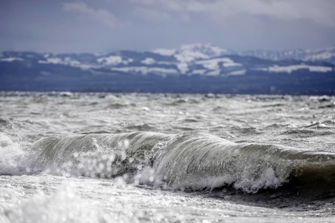 Storm Lolita raging on the rocky shore with waves in Hagnau