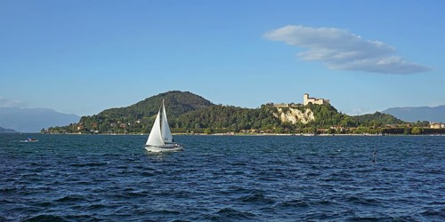Sailing boat and castle of Angera or Rocca Borromeo di Angera