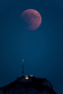 Lunar eclipse above the mountain station of Hohen Kasten
