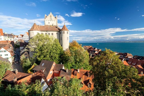 Meersburg Castle in the sunshine with a view of the Alps