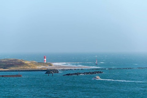 Dune with lighthouse on the beach