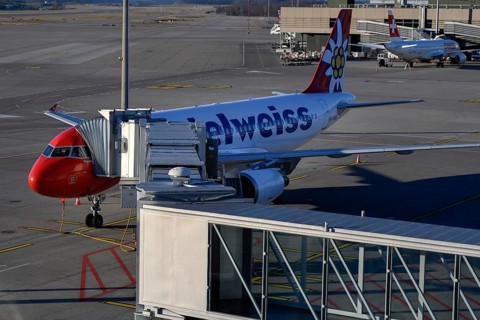 Aircraft Edelweiss Air with docked jetway