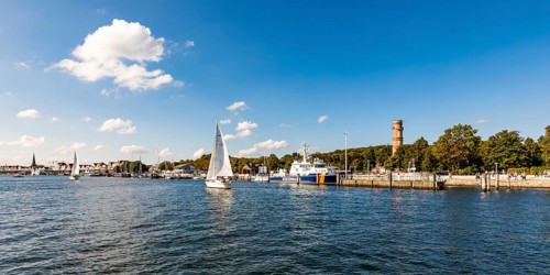 Sailing boats on the river Trave in front of the Trave promenade