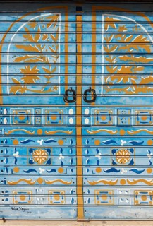 Colorful painted roller shutters on shop window