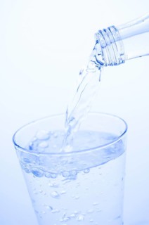Mineral water is poured into a glass