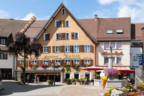 Historic building of the Butsch butcher's shop and Demetrius fountain on the town hall square in Loeffingen