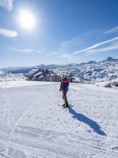 Blue sky above snowshoe hiker in winter landscape