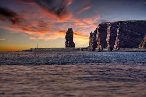 View from the sea to the rocky island of Helgoland with surf pillar Lange Anna