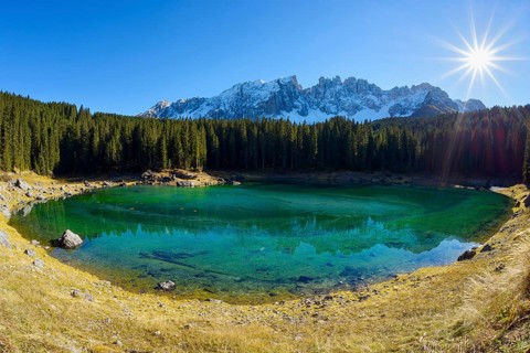 Carezza lake with sun