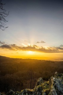 A Dramatic Sunset in the Evening with Clouds over a Valley in the Forest