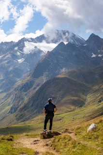 Hiker looking into the mountain massif of the Oetztal Alps in the rear Passeier Valley