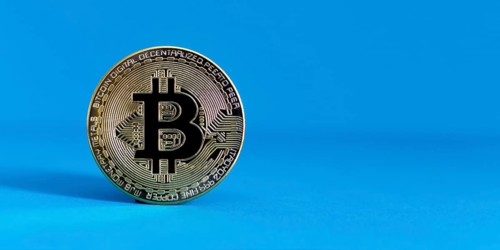 Bitcoin BTC crypto currency gold coin on blue background