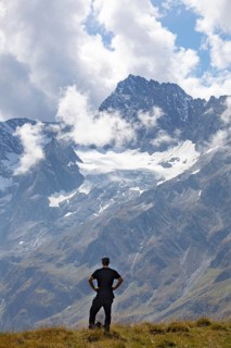 Hiker looking into the mountain massif of the Oetztal Alps in the rear Passeier Valley