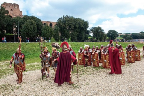 Traditional group of Roman legionaries in historical uniform equipment practising in Circus Maximus
