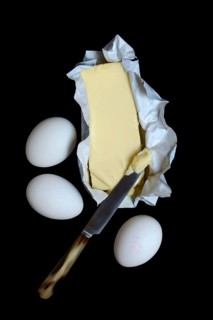 Butter in opened packaging and eggs