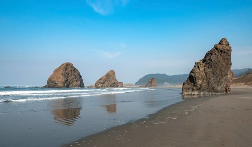 Sandy beach beach with sea and big rocks