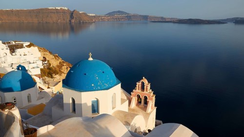 View down to white church with blue dome