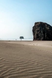 Sandy beach beach with sea and big rocks