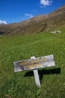 Alpine pasture Wooden sign Meadow no trespassing