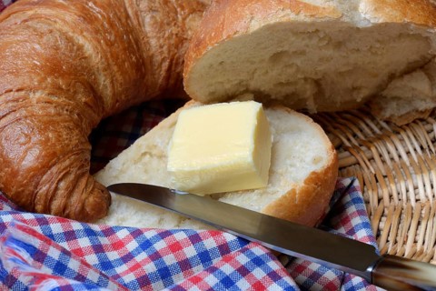 A piece of butter on a roll
