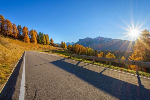 Mountain road with sun in autumn