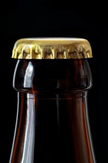 Beer bottle with gold coloured crown cork