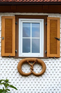 Residential house with wooden shingles as facade