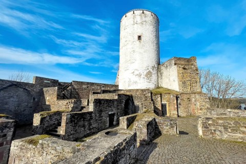 Ruin of foundation walls in former courtyard of Reifferscheid Castle in Eifel