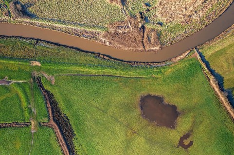 Top Down view from a drone over Meadows and Marshland around Clyst River in Topsham