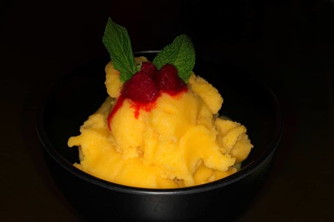 Mango sorbet with raspberries and fresh mint