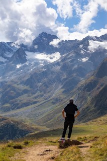 Hiker looking into the mountain massif of the Oetztal Alps in the rear Passeier Valley