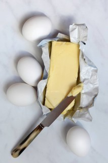 Butter in opened packaging and eggs