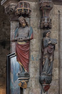 Coloured sculptures of the Man of Sorrows on the left and holy St. Matthew on the right
