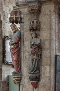 Coloured sculptures of the Man of Sorrows on the left and holy St. Matthew on the right