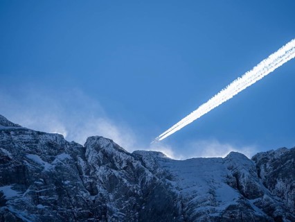 Plane over summit of the Hochtor Group in morning light