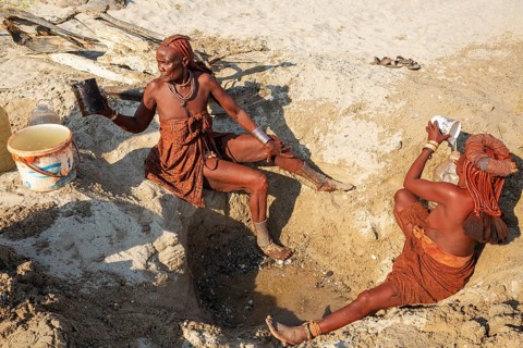 Himba women collecting water at a water hole