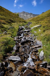 Mountain stream with waterfall in the rear Passeier Valley