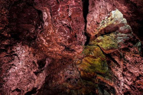 Colourfully illuminated areas of the Cueva de los Verdes